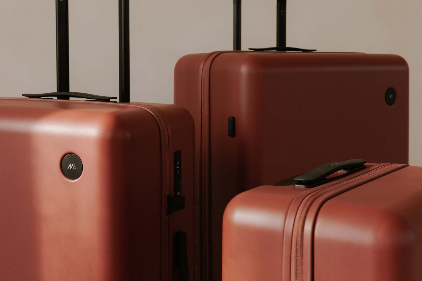 Monos luggage in different sizes in Terracotta.