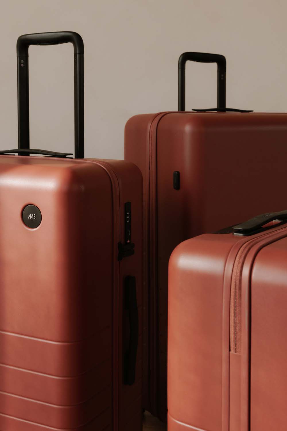 Different sizes of Monos luggage in Terracotta