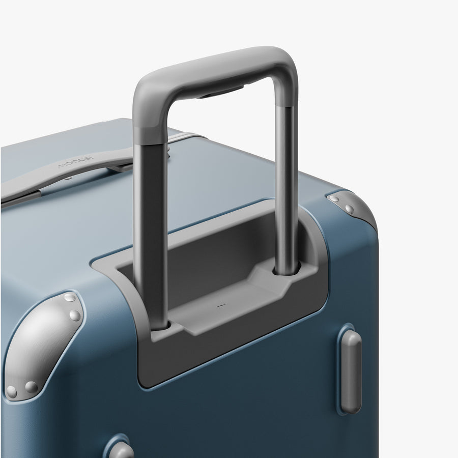 Elemental Blue | Extended luggage handle view of Hybrid Trunk in Elemental Blue