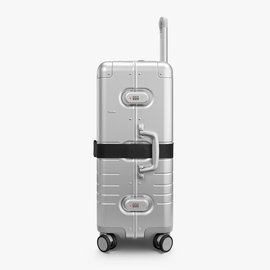 Midnight Black | Side view of Aluminum suitcase with the Midnight Black Luggage Strap secured around it