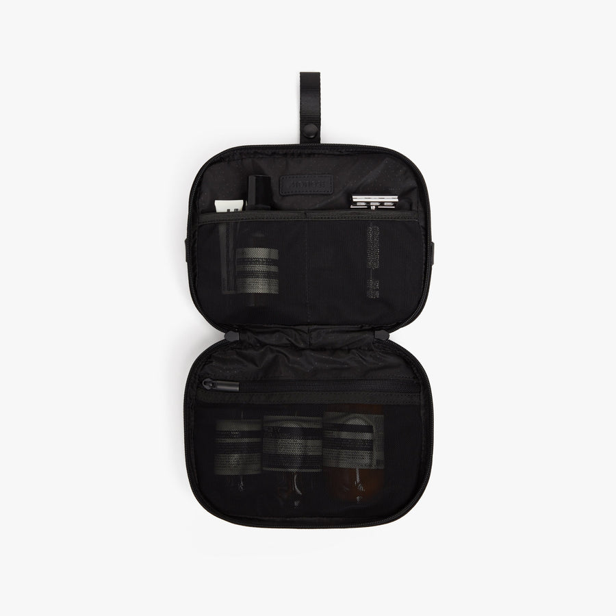 Carbon Black | Open front view of Metro Hanging Toiletry Case in Carbon Black