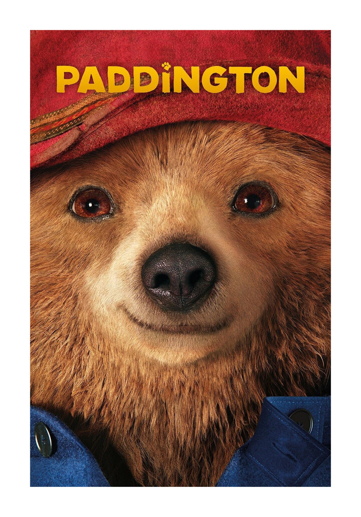 A close-up movie poster for Paddington, featuring the face of the friendly bear wearing his signature red hat and blue coat.