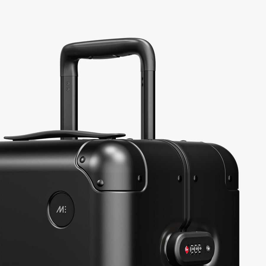 Caviar Black | Luggage handle view of Aluminum Check-In Medium in Caviar Black