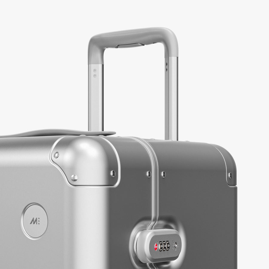 Aspen Silver | Luggage handle view of Aluminum Trunk in Aspen Silver