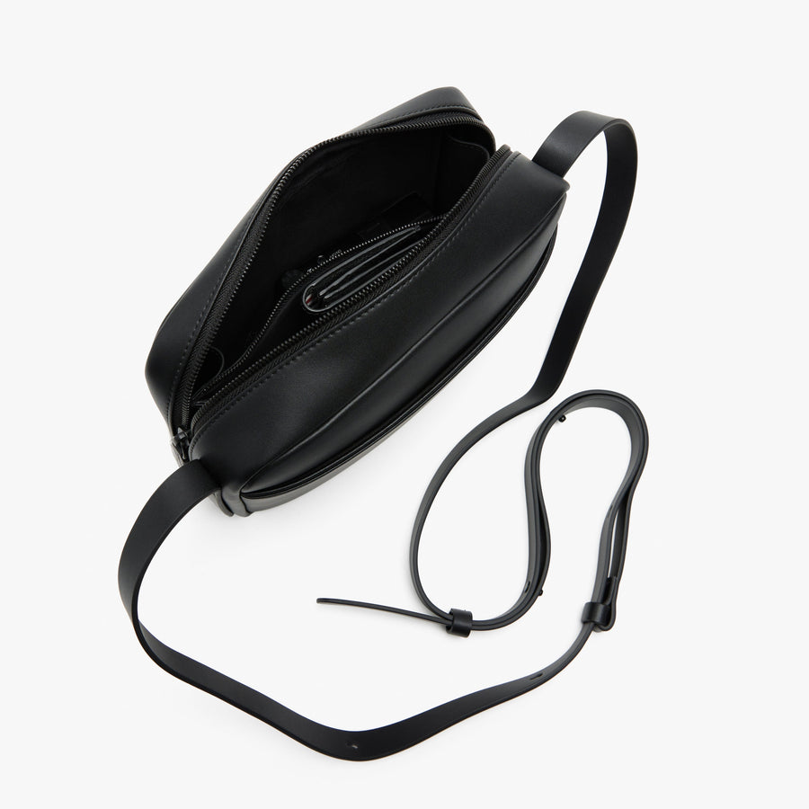 Carbon Black (Vegan Leather) | Angled view of Metro Crossbody in Carbon Black