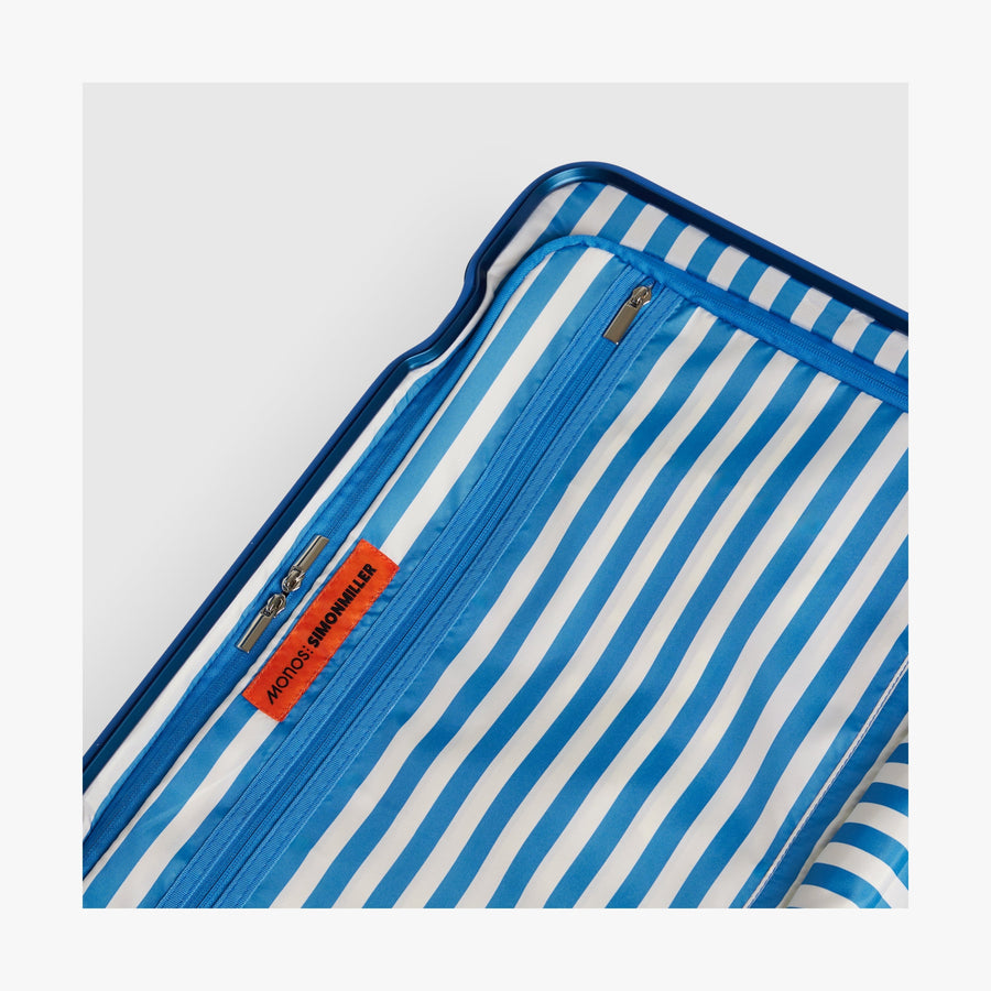 Coastal Blue | Close-up view of the Hybrid suitcase interior in Coastal Blue, featuring the Poplin Stripe Coastal Blue zipped compartment