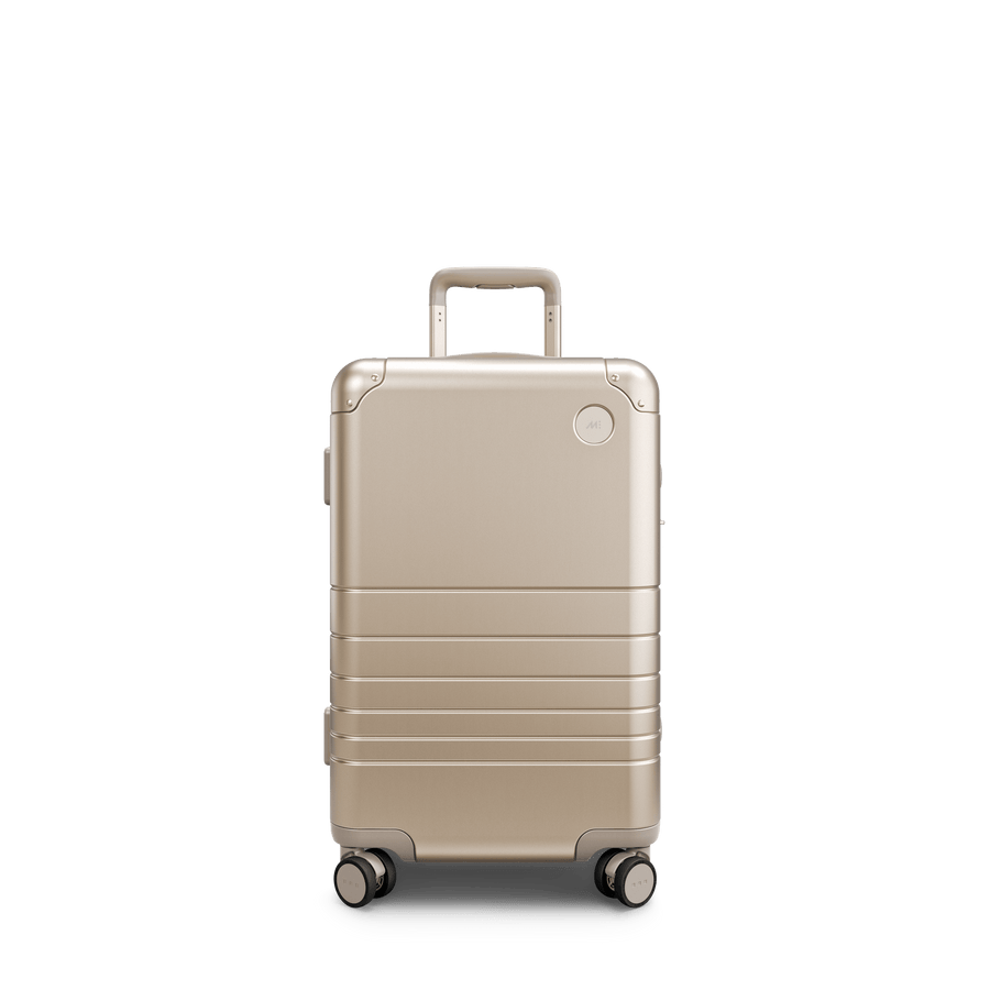 Champagne Gold Scaled | Front view of Aluminum Carry-On Plus in Champagne Gold