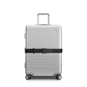 Front view of Aluminum suitcase with the Midnight Black Luggage Strap secured around it