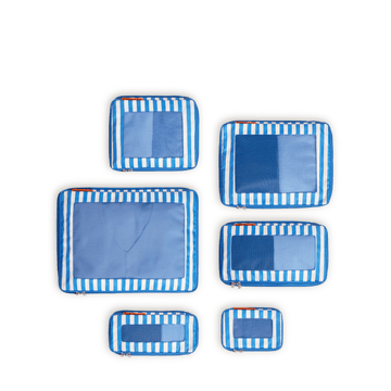 Set of four Poplin Stripe Coastal Blue compressible packing cubes arranged flat to show all sizes