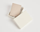 Slim Wallet in Ivory placed in an elegant white gift box lined with tissue paper.