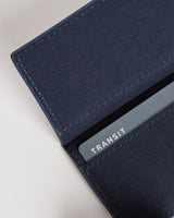 A close-up of the interior of a slim wallet in oxford blue with a transit card partially visible in one of the slots, showcasing the functional card storage.