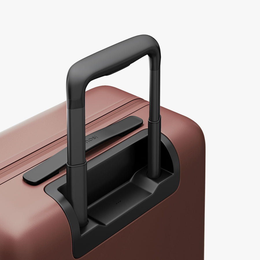 Terracotta | Extended luggage handle view of Carry-On Pro Plus in Terracotta