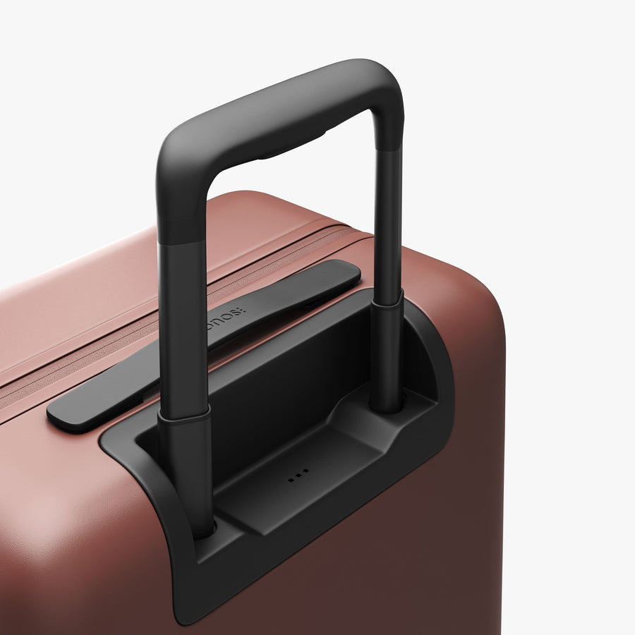 Terracotta | Extended luggage handle view of Carry-On Plus in Terracotta